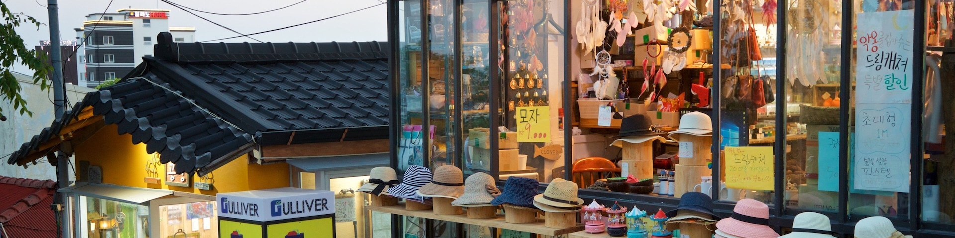 A store with a variety of hats displayed outside.
