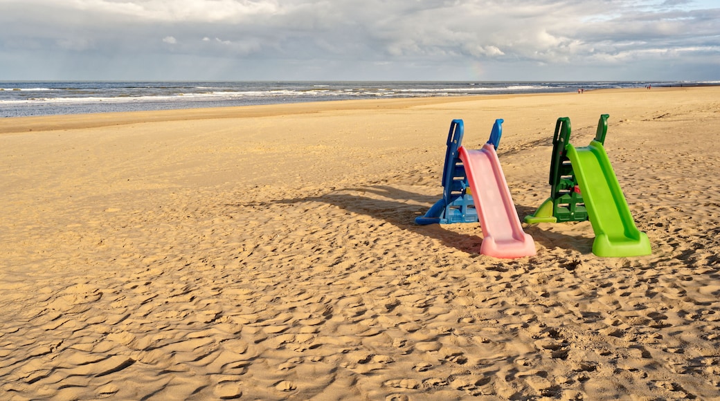 Two colorful playground slides on an almost empty beach. North Holland dune reserve, Egmond aan Zee, Netherlands.