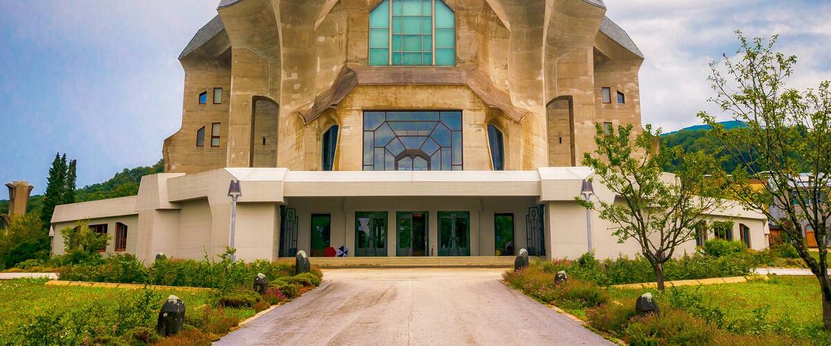 A large, modern building with a unique octagonal shape and a large central window.
