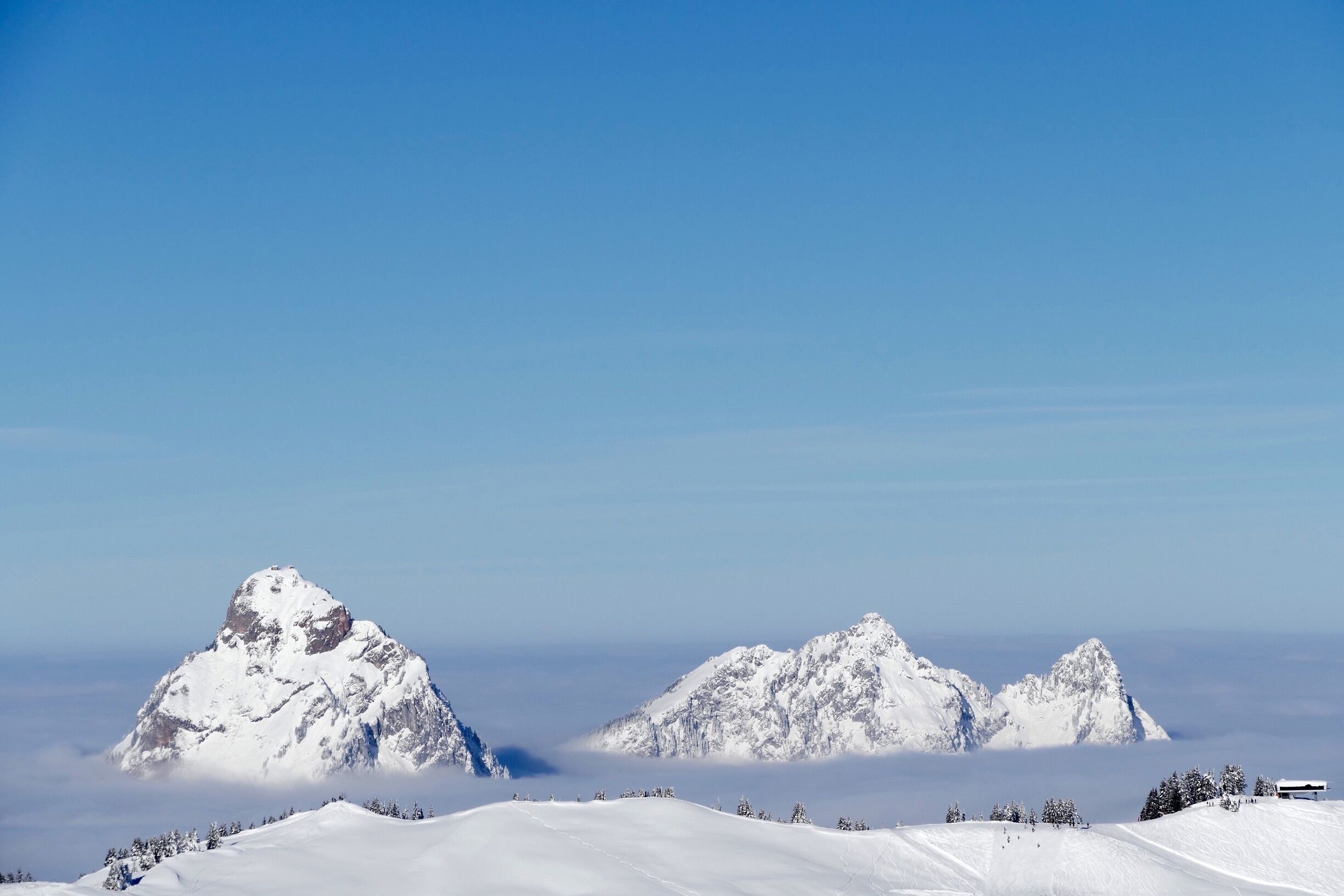 A snow-covered mountain range with a clear sky.