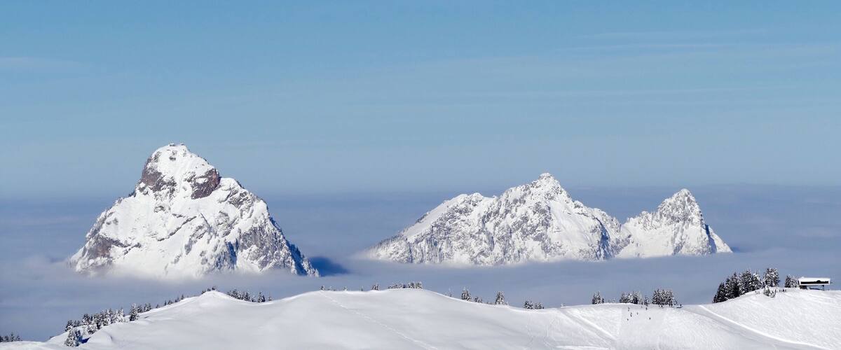 A snow-covered mountain range with a clear sky.