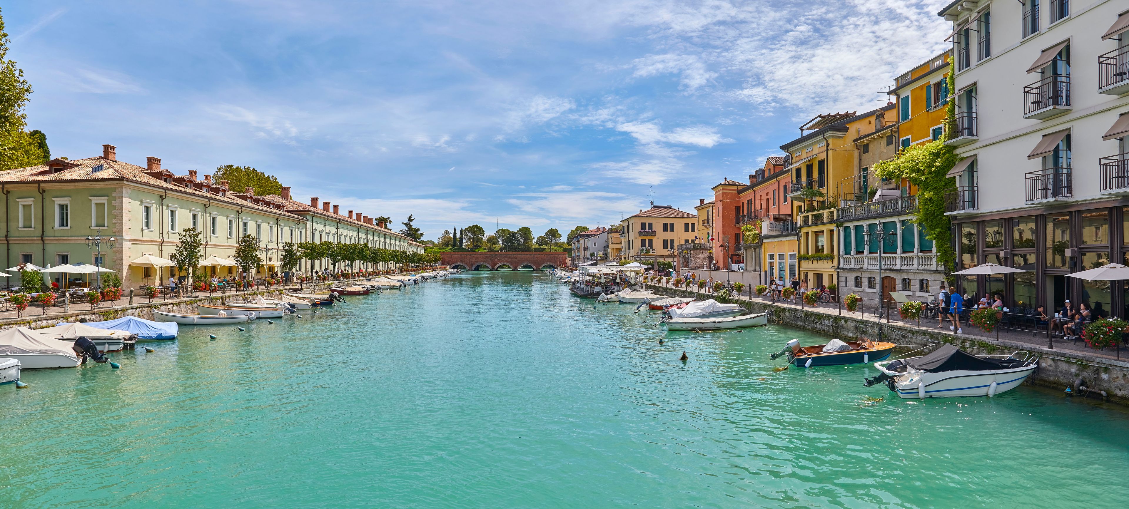 A canal lined with colorful buildings and boats docked along the water.