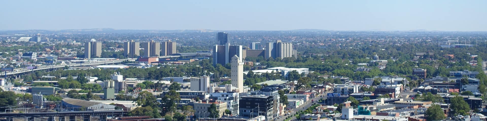 Background texture of elevated Melbourne 's metropolitan view of western suburbs. Aerial view of suburban houses against cloudless blue sky.