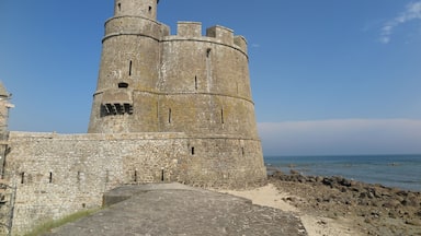 A historic stone tower by the sea.