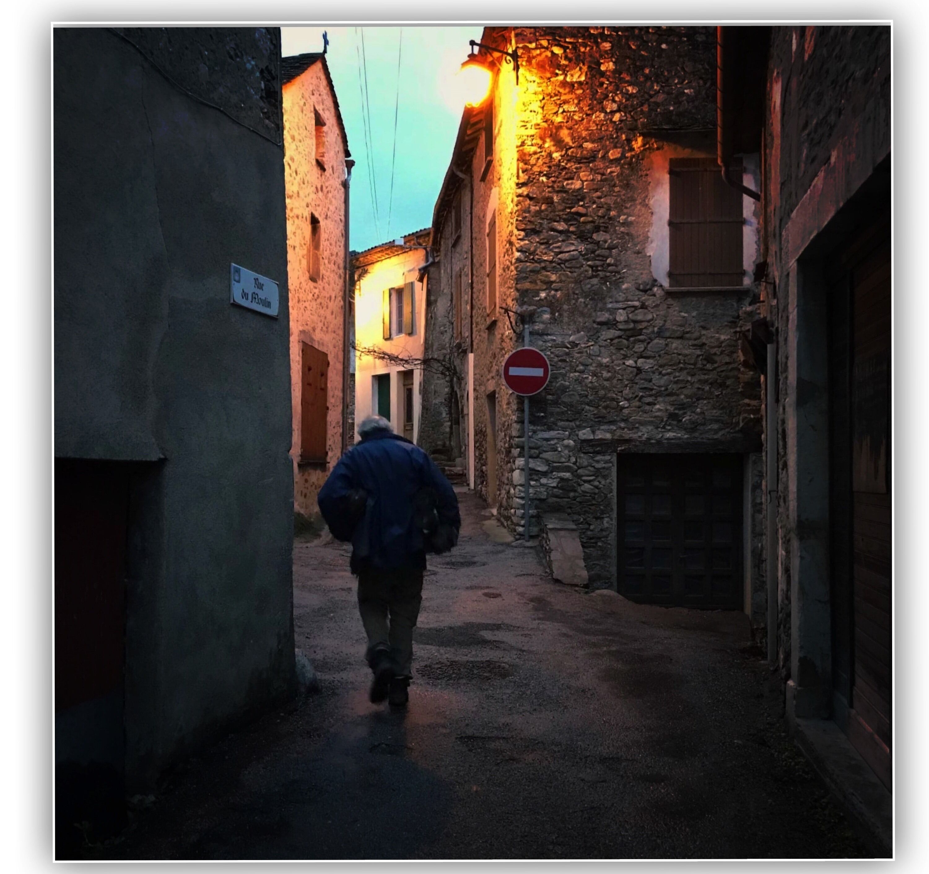 A very quiet sunday afternoon in the village of Olargues, France. I saw this man carrying firewoods.