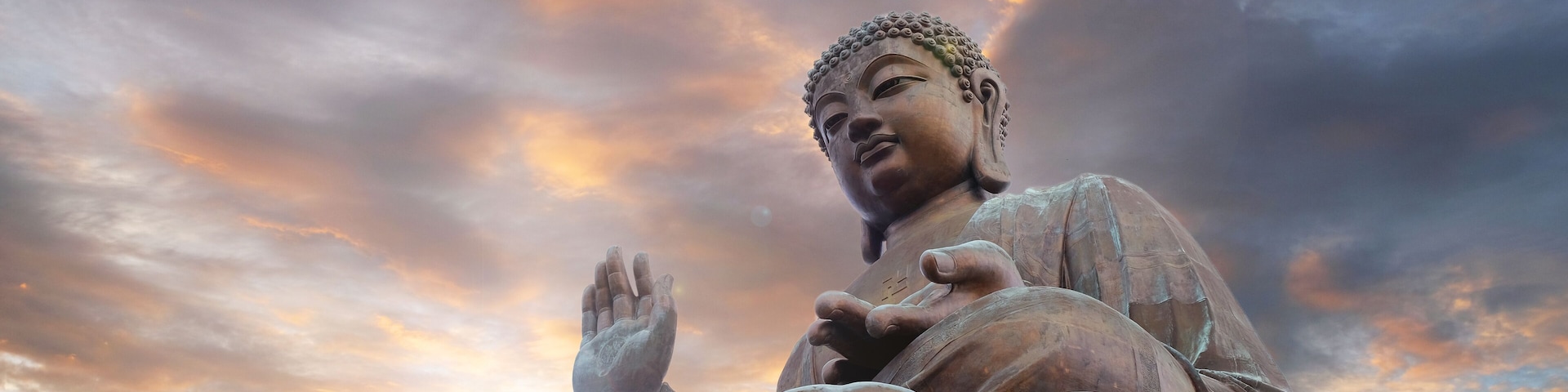 Tian Tan Buddha with sun flare and twilight sunset background located at Ngong Ping, Lantau Island, in Hong Kong