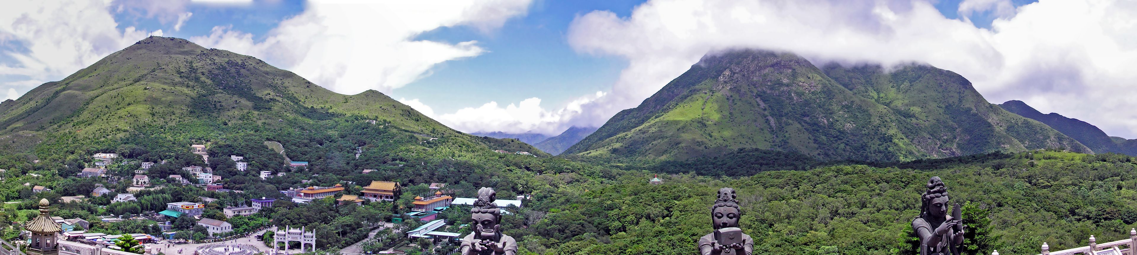 A mountainous landscape with a village nestled in the valley.