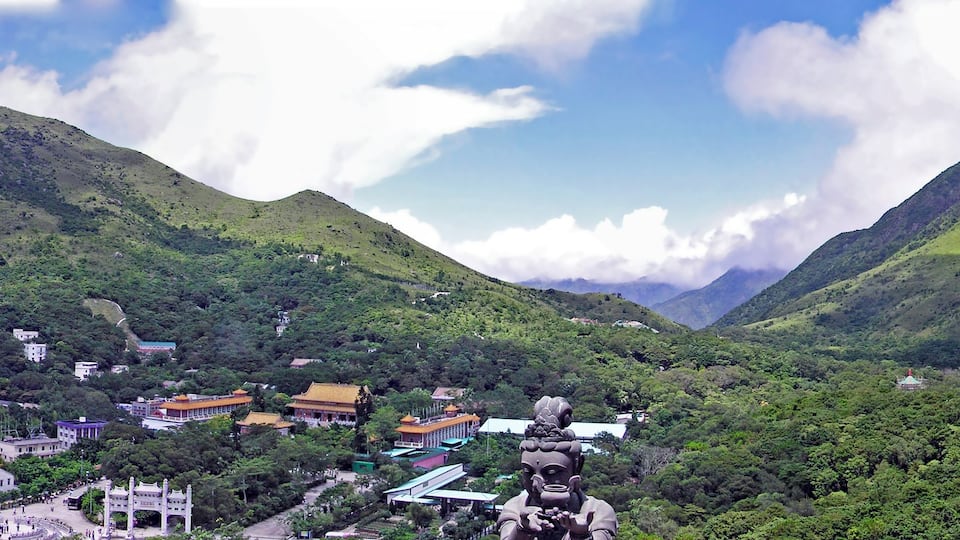 A mountainous landscape with a village nestled in the valley.