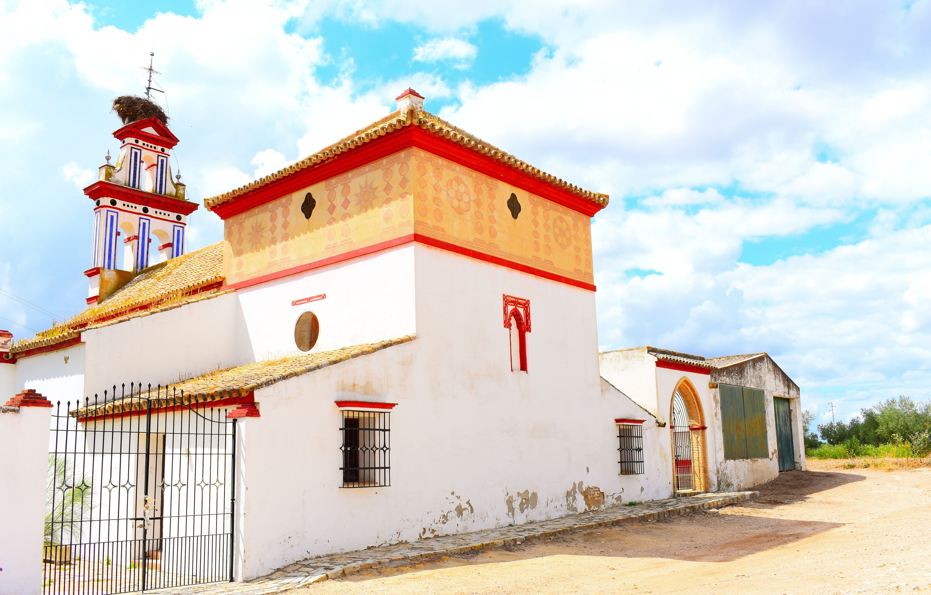 A white church with red trim and a bell tower.