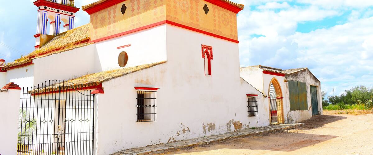 A white church with red trim and a bell tower.