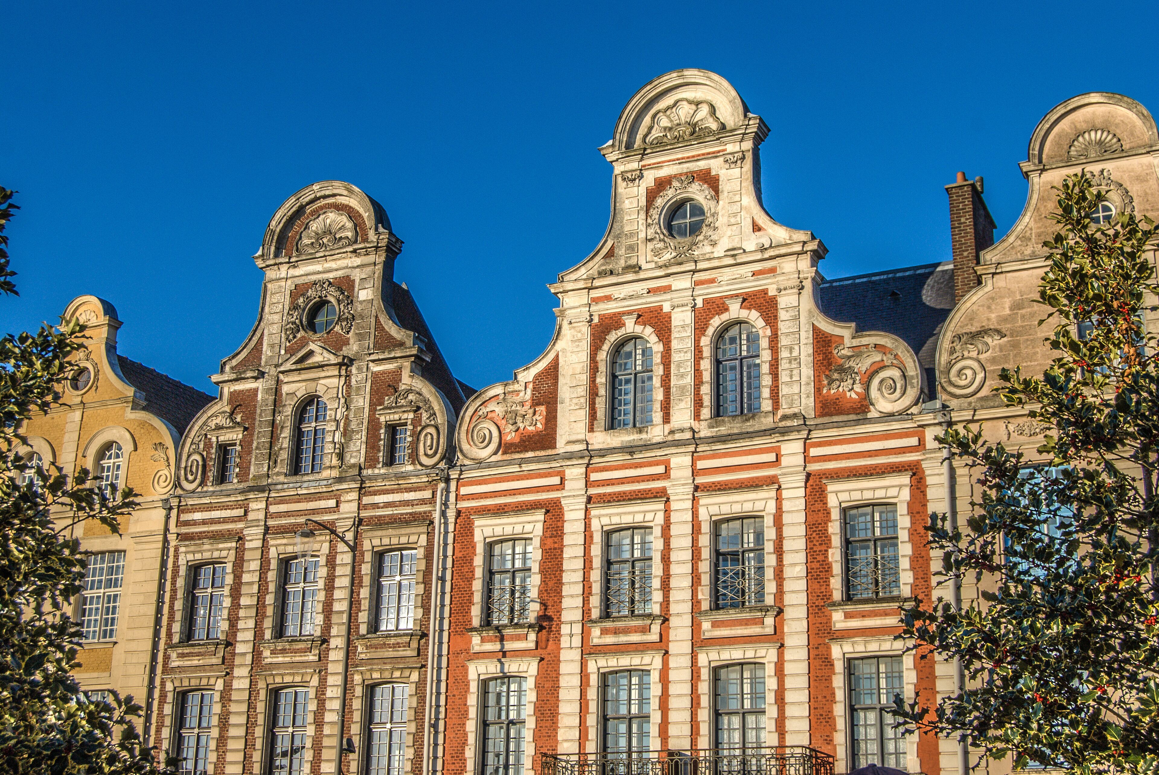 A historic building with ornate architectural details and multiple windows.