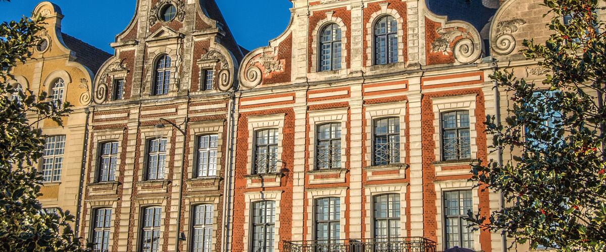 A historic building with ornate architectural details and multiple windows.