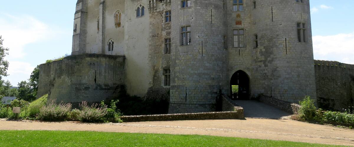 A large medieval castle with three prominent towers and a central entrance.