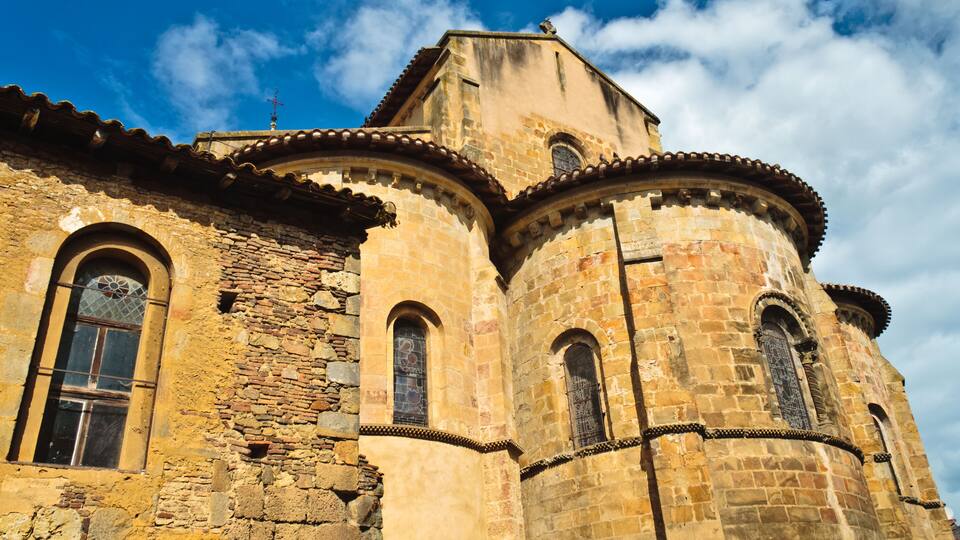 A historic stone church with arched windows and a bell tower.
