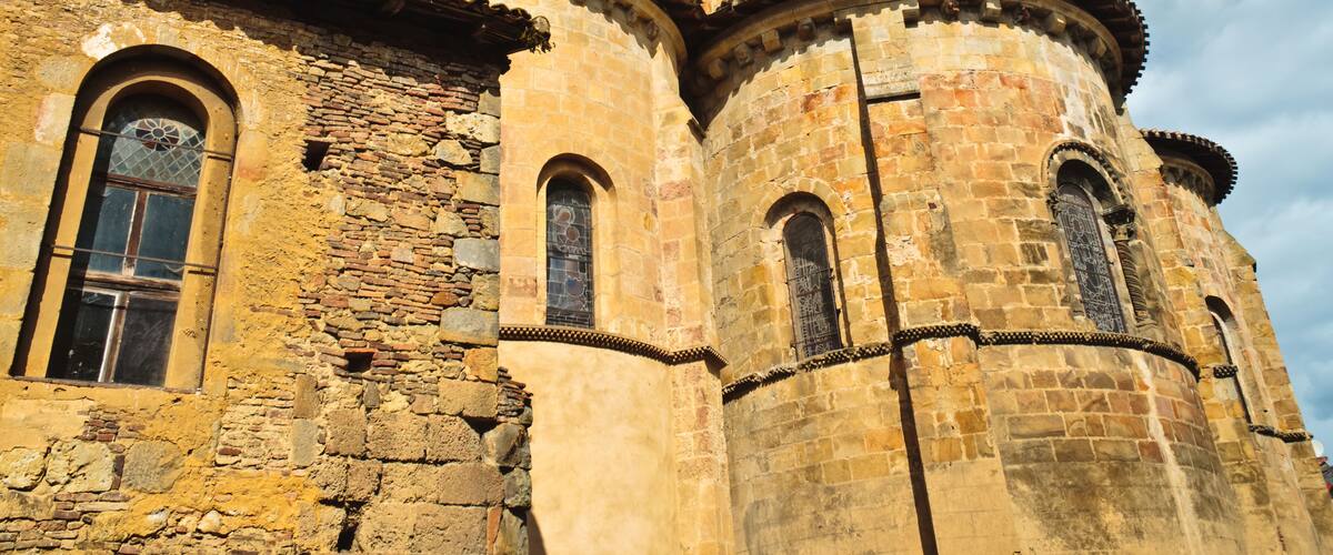 A historic stone church with arched windows and a bell tower.