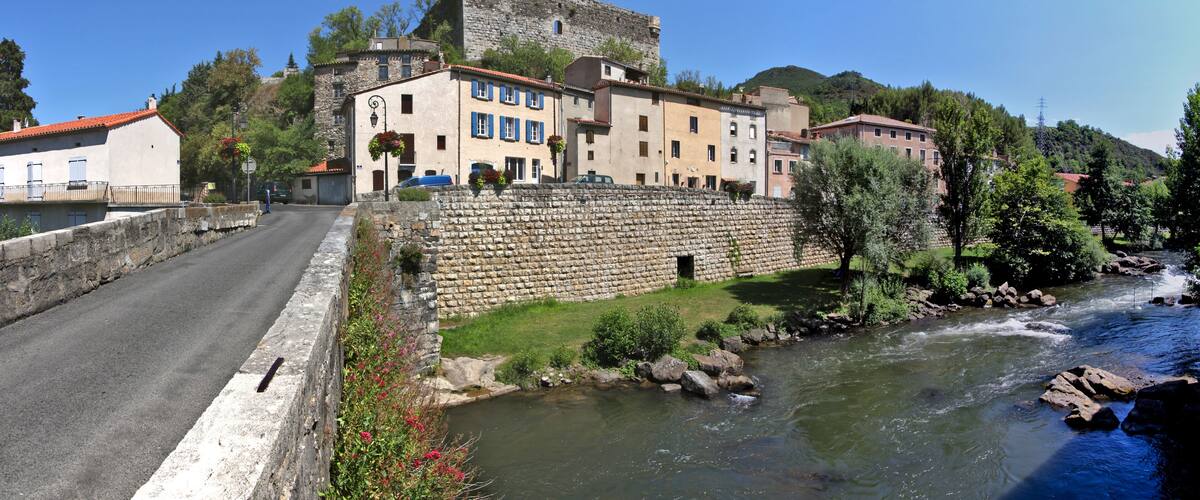 Aude river cityscape with the medieval castle ruins on top of the old town of Quillan, Occitanie region in France