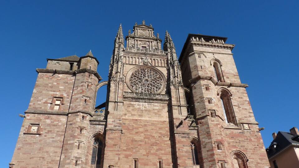 A large cathedral with a prominent rose window and twin towers.