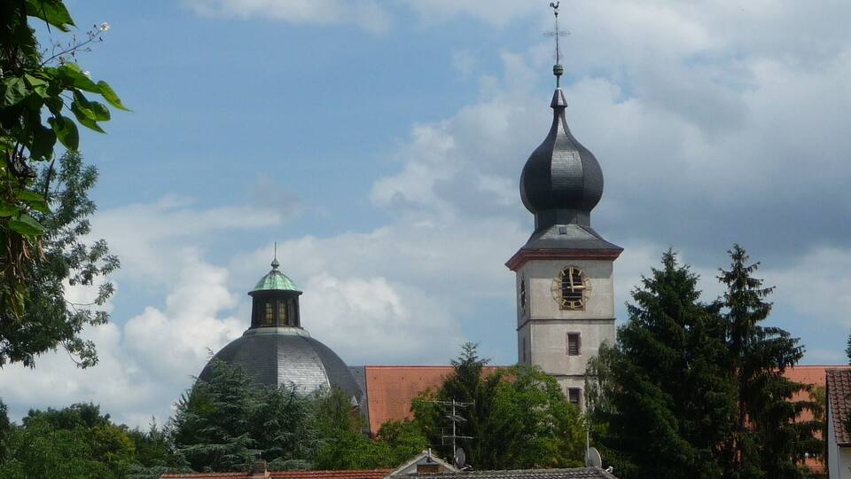 A church with a clock tower and a dome.