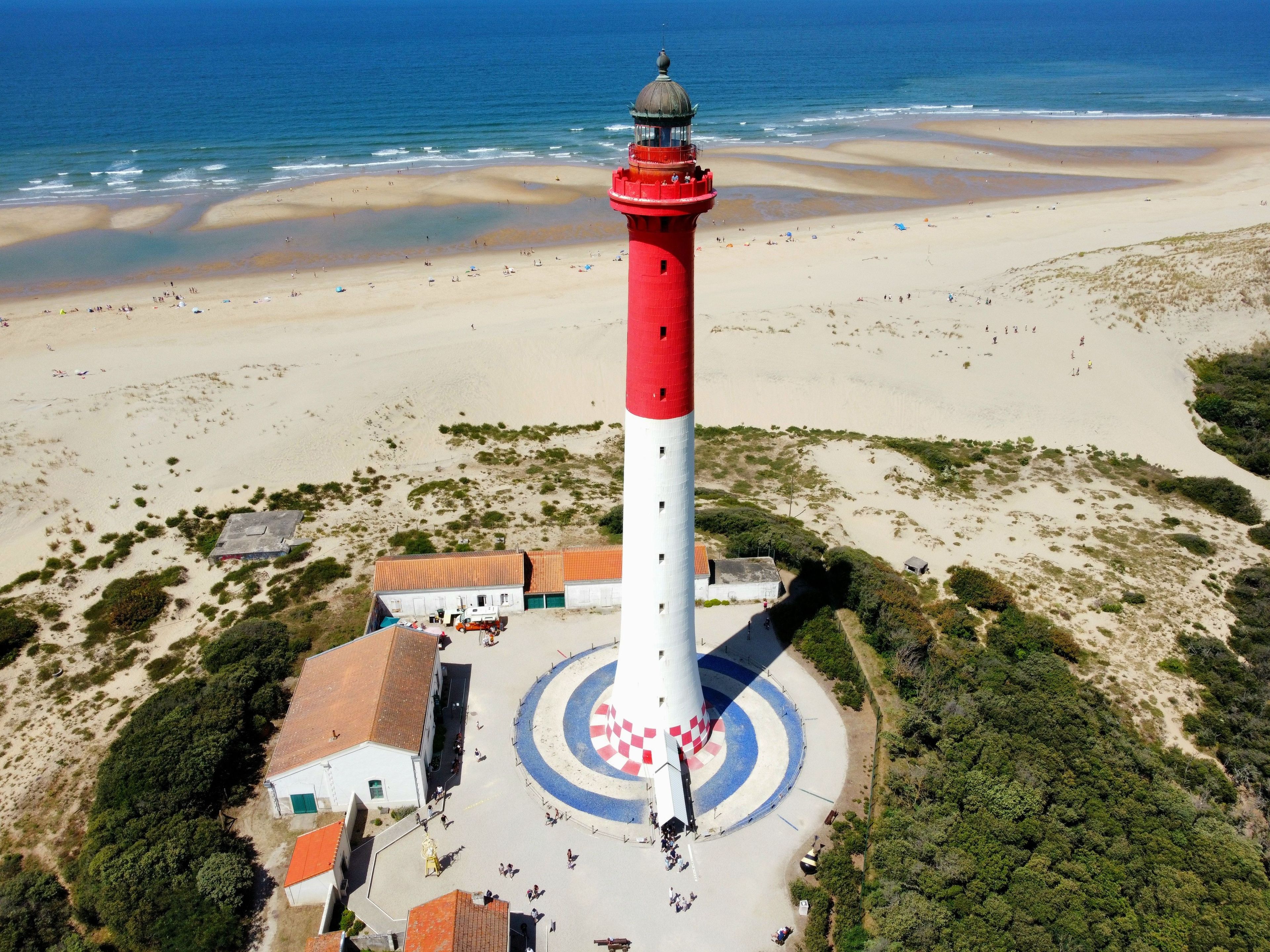 Lighthouse of La Coubre in La Tremblade, France with a blue sea on the horizon