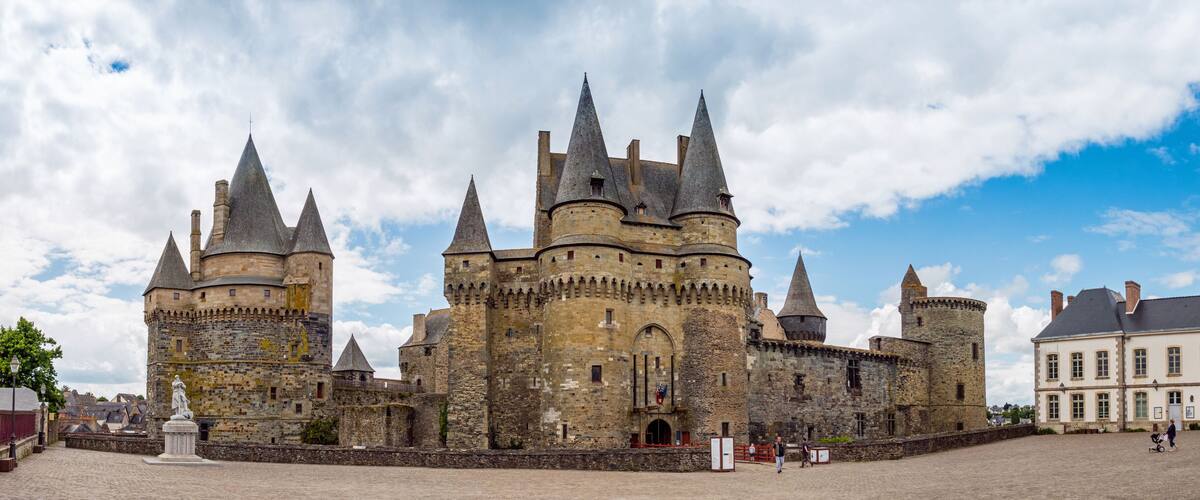 A historic castle with multiple towers and a large courtyard.
