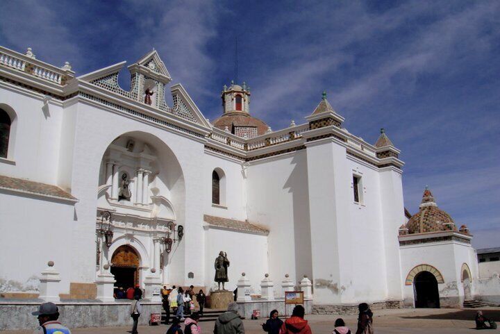 A white colonial-style church with a dome and arched entrance.