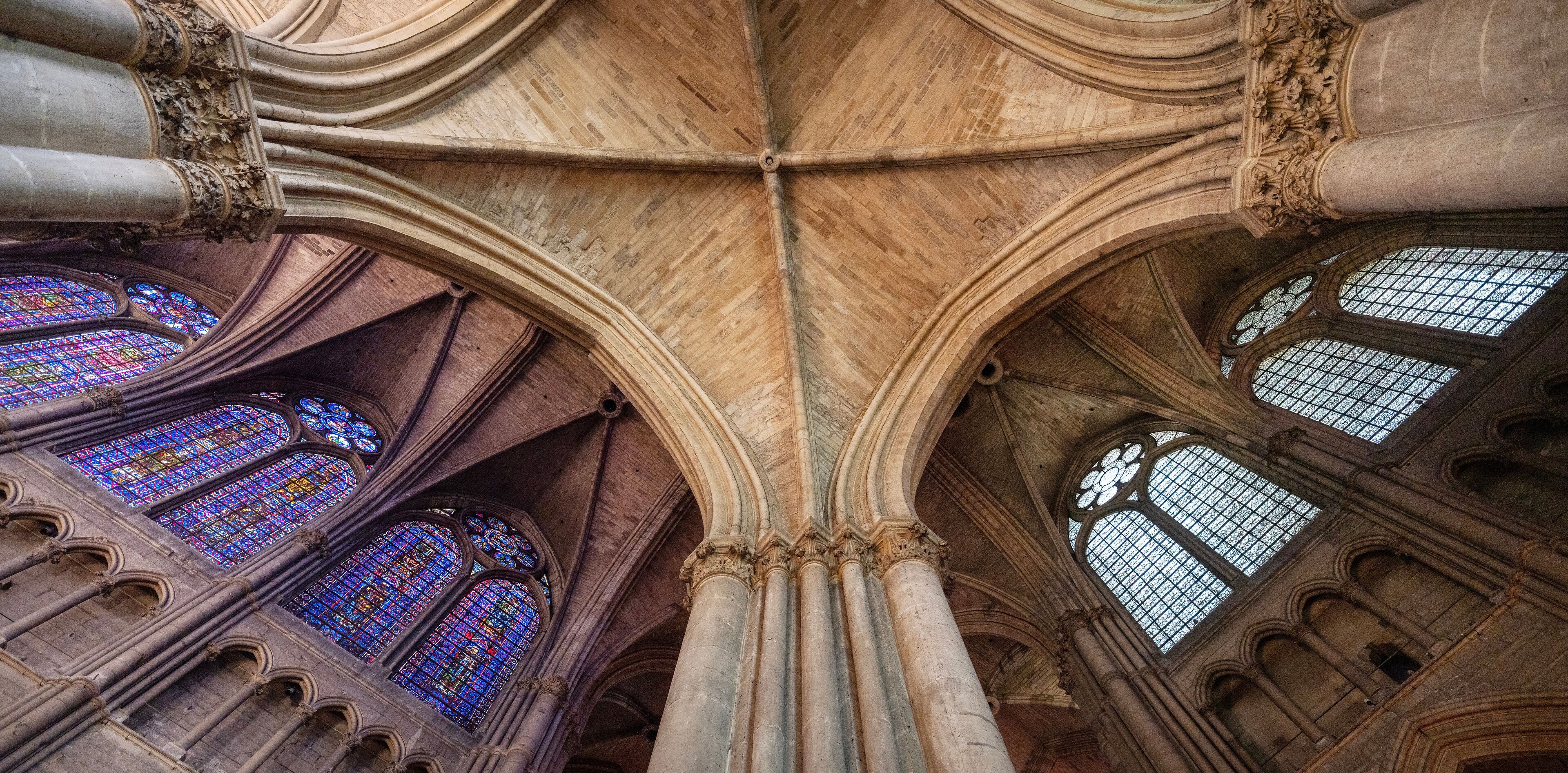 A cathedral interior with Gothic arches and stained glass windows.