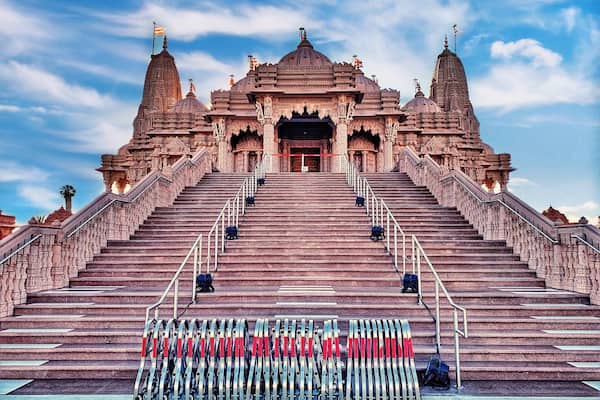 Ein Tempel mit aufwendiger Architektur und einer großen Treppe, die zu ihm hinaufführt.