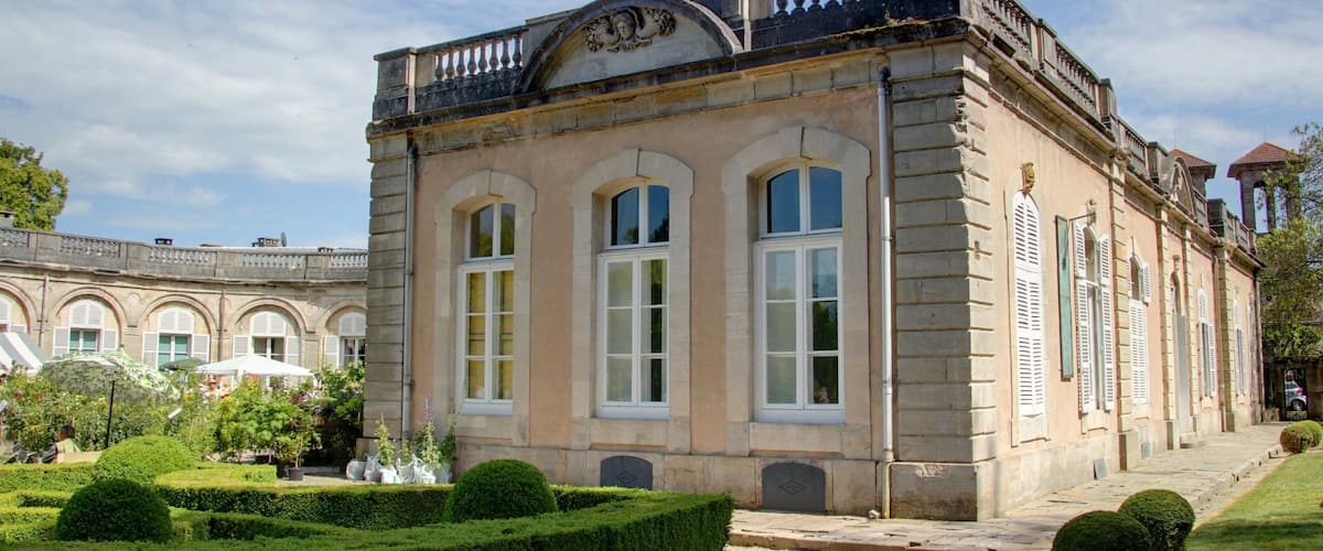 A historic building with arched windows and a balcony.
