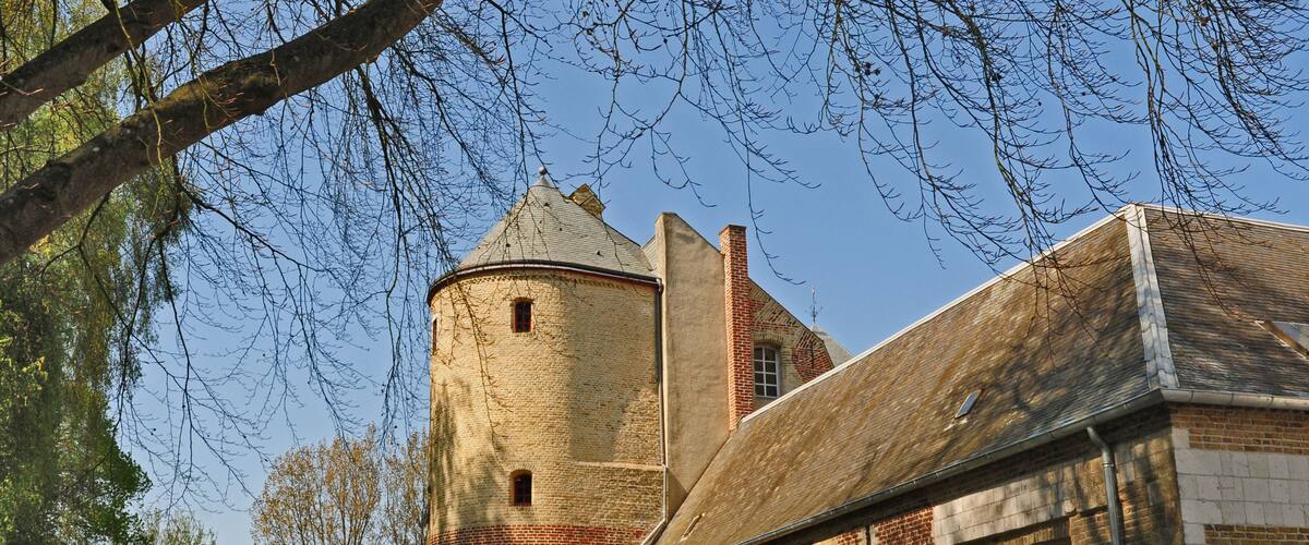 A historic building with a round tower and brick walls.