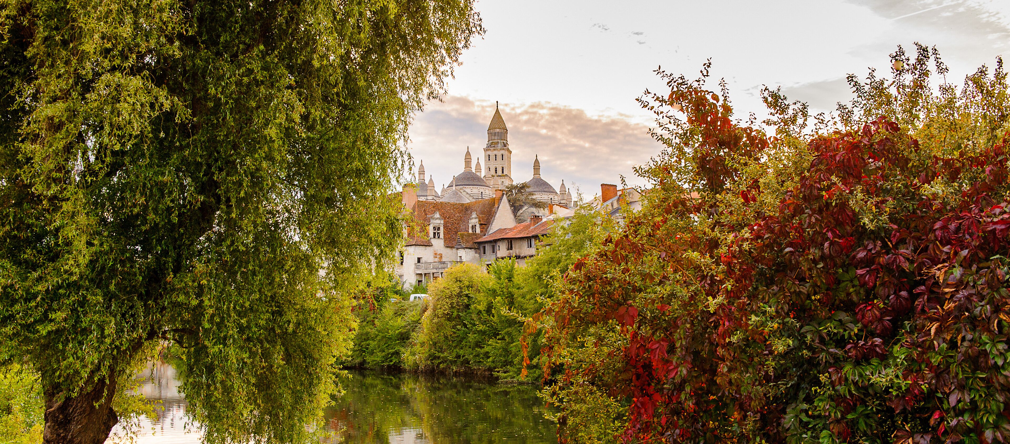 A historic town with a prominent church and a river.