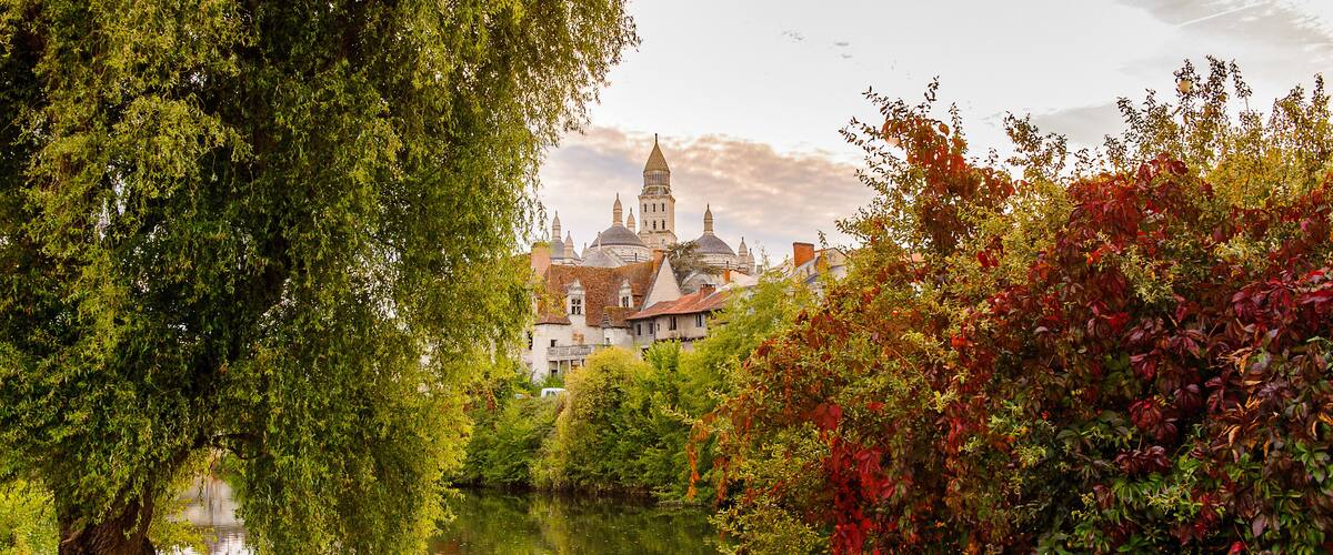 A historic town with a prominent church and a river.