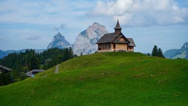 View of a small chapel in front of a Kleiner Mythen mountain in Muotathal, Switzerland