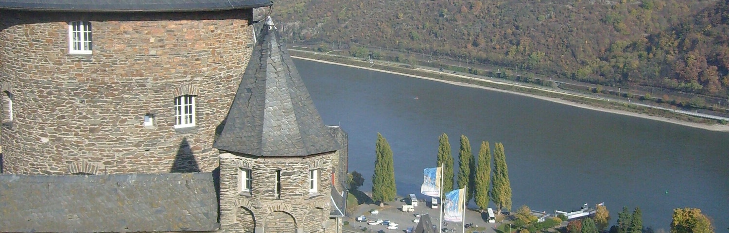View from the top of the bulwark onto the castles terrasses, the city of Bacharach and the rhine valley.