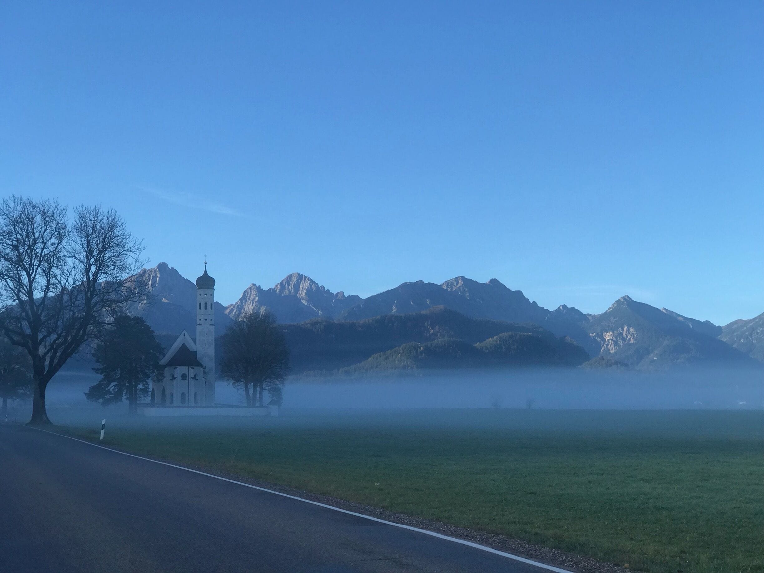 En route to Tegelbergbahn on an early morning .. this view from the road to the local church was mystical (st Coloman Catholic Church )