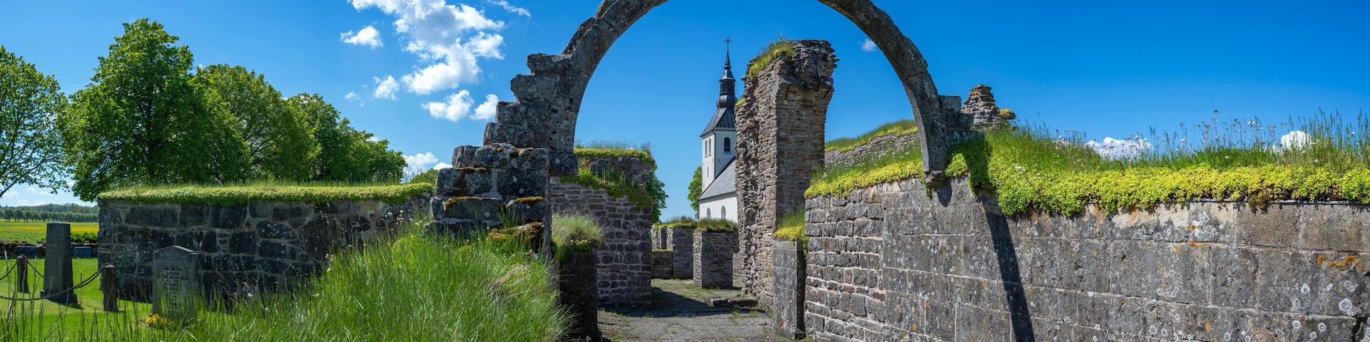 Gudhem Historical Monastery Ruin and Church in rural environment with overgrown stone walls and arches during Summer near Falkoping Vastra Gotaland, Sweden.