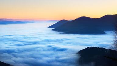 Beautiful view of the sunset in the mountains and valleys with fog. French Alsace, Vosges mountains