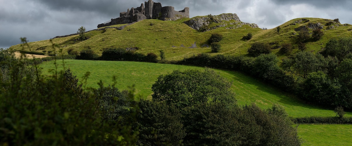 Carreg Cennen castle sits high on a hill near the River Cennen, in the village of Trap, four miles south of Llandeilo in Carmarthenshire, south Wales