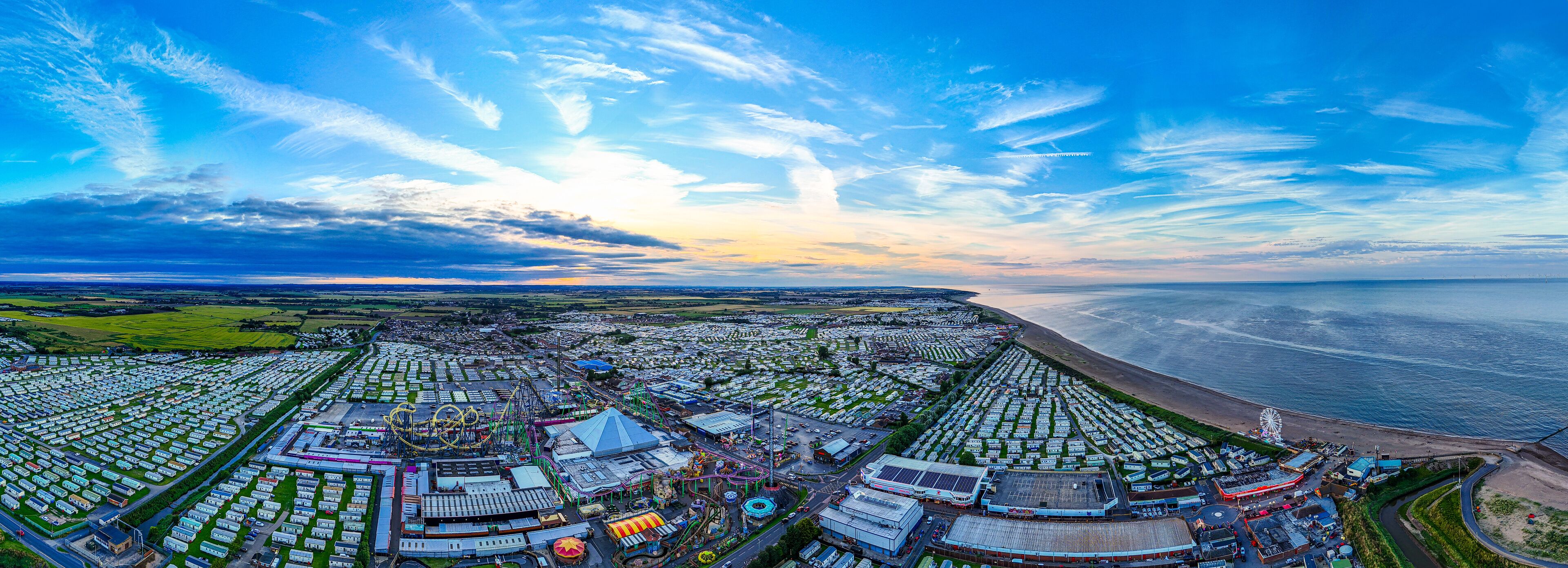 Sunset Aerial Panoramic View of the UK Seaside Ingoldmells, a busy tourist town with something for everyone, from stunning campsites to a sunset to die for, showcases the beauty of a serene sunset