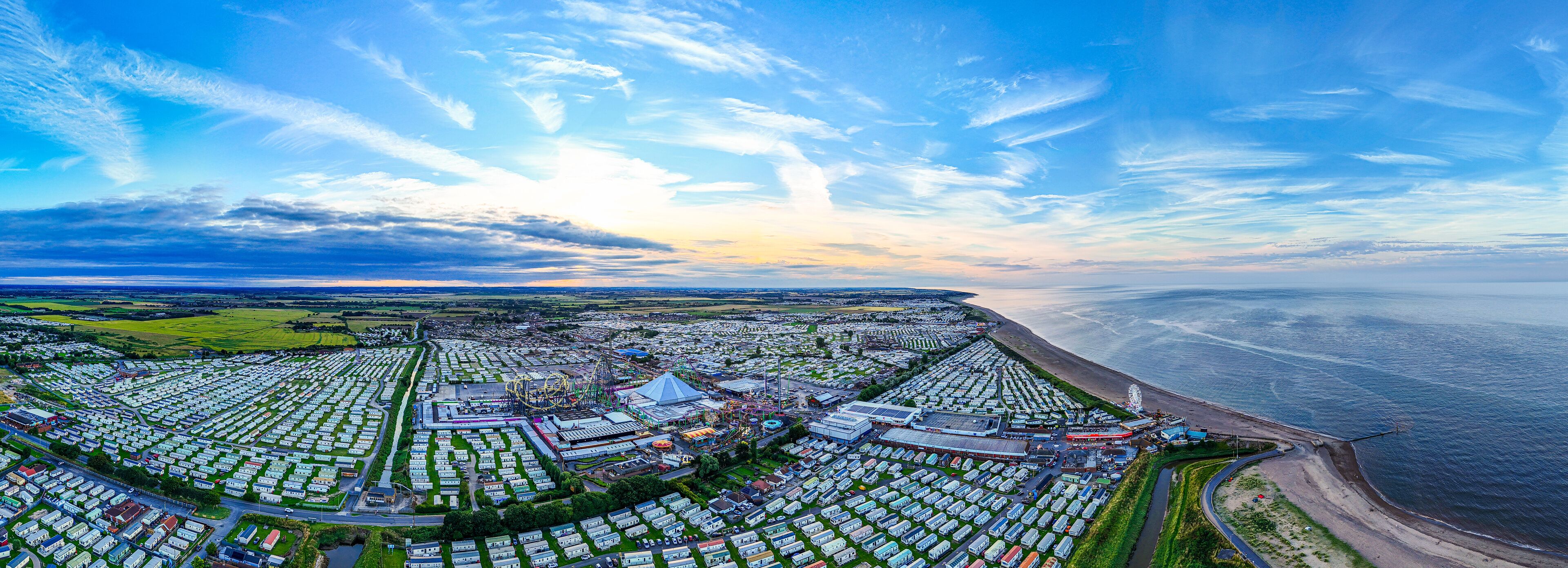 Sunset Aerial Panoramic View of the UK Seaside Ingoldmells, a busy tourist town with something for everyone, from stunning campsites to a sunset to die for, showcases the beauty of a serene sunset