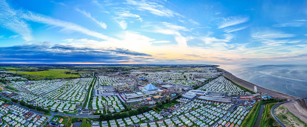Sunset Aerial Panoramic View of the UK Seaside Ingoldmells, a busy tourist town with something for everyone, from stunning campsites to a sunset to die for, showcases the beauty of a serene sunset