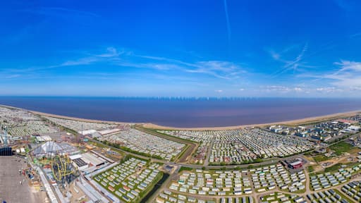 Aerial wide photo of the town centre of Skegness showing the the sandy beach near fairground rides in the East Lindsey district of Lincolnshire, England