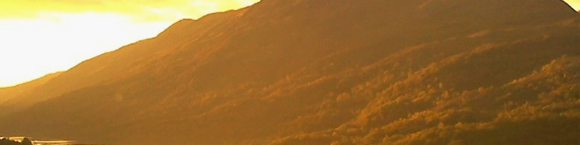 In Kinlochleven, Scotland. Kinlochleven is in the Scottish Highlands and is the penultimate stop on the West Highland Way. I had a memorable time there in October 2015! And got a great shot here, with the sunset on the mountain! In fact, this sunset was one of my favorite moments of that entire Scottish trip. Watching the sunset evolve was simply spectacular...