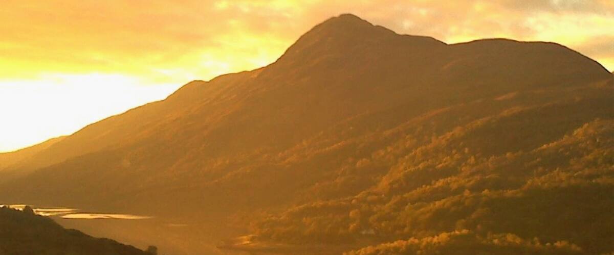 A mountain range with a river flowing through a valley.