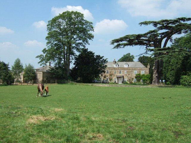 West Park Farm. A mare and her foal nibble the grass in front of West Park Farm. Near to Whittlebury this lovely old farm obviously belonged to a Gentleman Farmer in the past. Much of its land is now taken over by Whittlebury Park Golf Course.