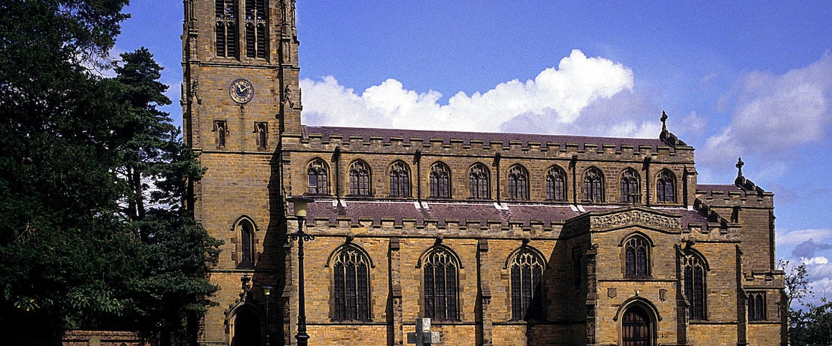 A large historic church with a tall tower and arched windows.