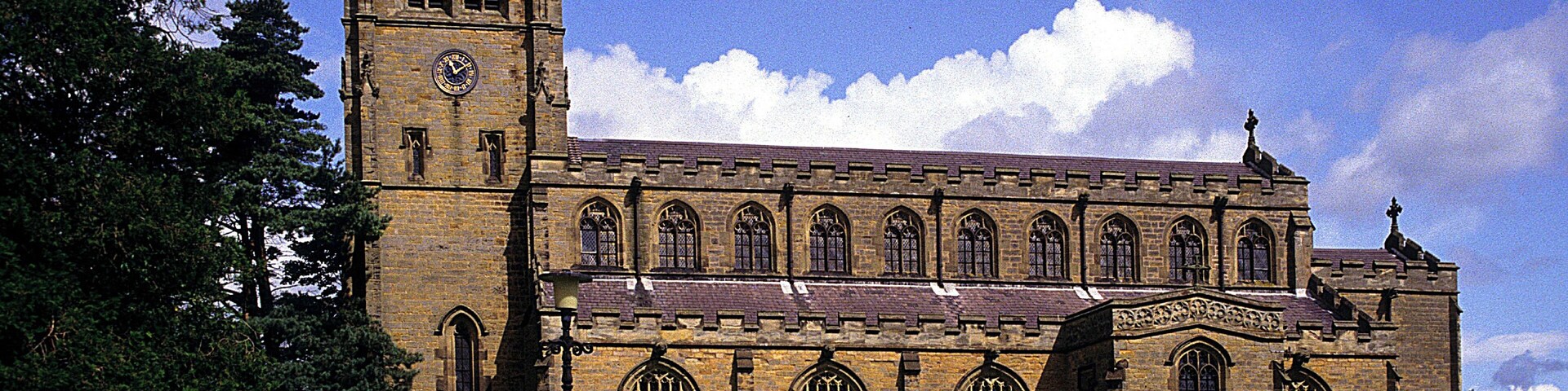 A large historic church with a tall tower and arched windows.