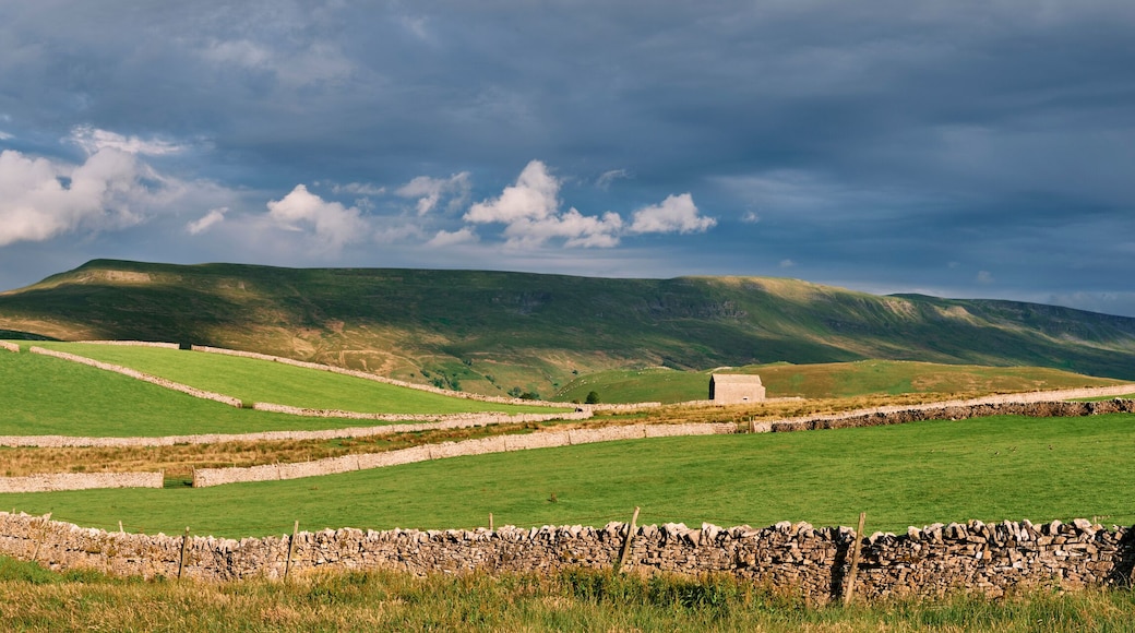 Barns at sunset with Wild Boar Fell beyond. Cumbria, UK.