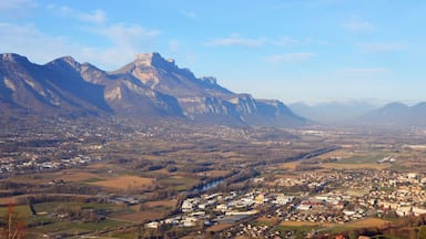 A town nestled in a valley with mountains in the background.
