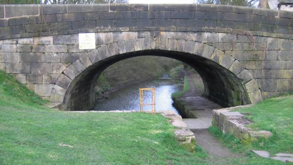 Lancaster Canal, Whittle-le-Woods Looking through the Chorley Old Road canal bridge, towards Whittle Tunnel on the abandoned southern section of the Lancaster Canal. A plaque on the other side of the bridge states that the first loaded barge passed through the tunnel on 1 June 1803.