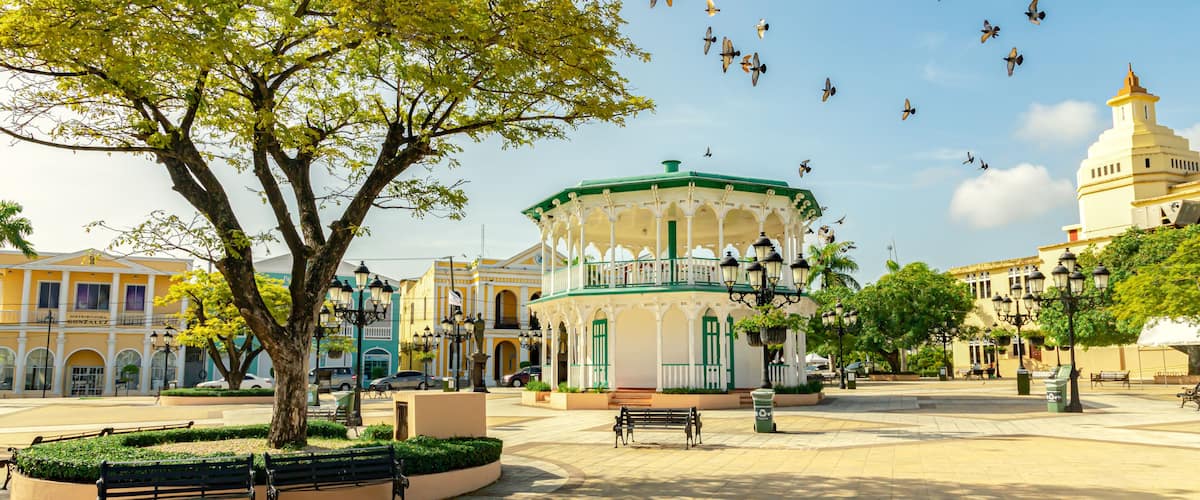 A plaza with a gazebo, benches, and a tree.
